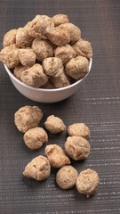 Raw soya chunks on dark background. Healthy, nutritious soybean meat, chunks isolated.Vegan food concept.