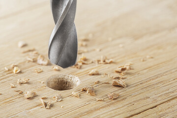 drill bit with steel triangle ruler make sink in hole for screw in wooden oak plank