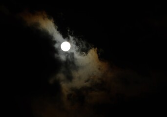 Bright full moon shining through the clouds on dark night. - Powered by Adobe