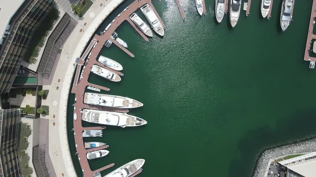 An Aerial 4k video of circular Marina where many yachts are docked