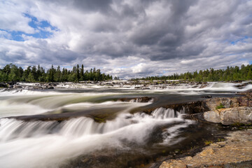 Fototapeta na wymiar view of the Trappstegsforsarna waterfall in northern Sweden