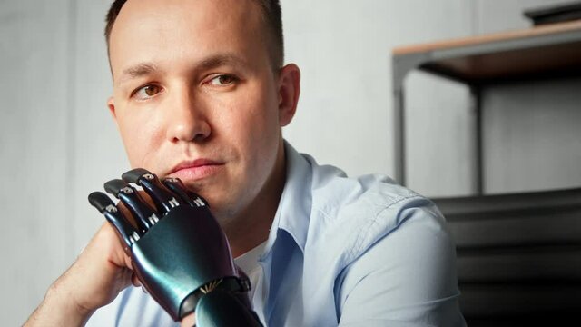 Serious cyborg disabled man with bio prothesis thinks