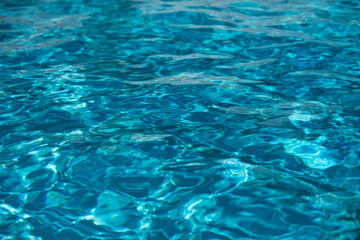 Fototapeta na wymiar Abstract ripple wave and clear turquoise water surface in swimming pool, blue water wave for background and abstract design.