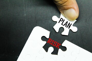 white puzzle with the words plan and risk