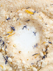 a slide of pink coarse sea salt with dried flowers for baths