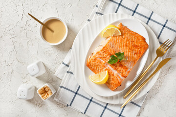 grilled salmon fillet on a white platter