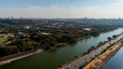 Fototapeta premium View of Marginal Pinheiros with the Pinheiros river and modern buildings in Sao Paulo, Brazil. With a place to do aquatic exercises in São Paulo