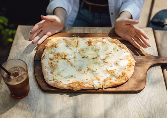 Top view. Woman in restaurant eating pizza and drinking coffee.