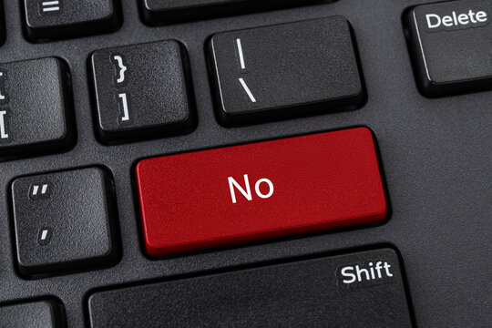 Desktop keyboard with No button. Red key with word No on a black computer keyboard. Keypad enter button with message. Concepts of refusal, disagreement and unacceptability.