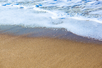 Wave of the sea on the sand beach