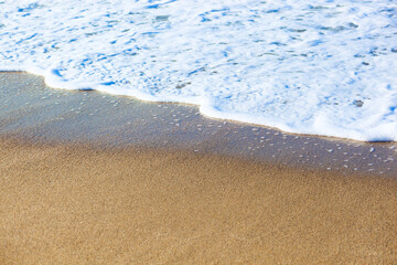 Wave of the sea on the sand beach