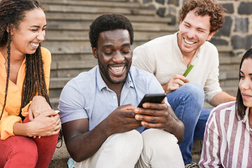Young multiracial people using smartphone in the city - Millennial friends having fun together...