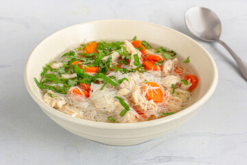 A Bowl of Fresh and Healthy Chicken Soup with a Spoon  Close Up Photo