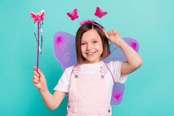 Photo of adorable cute school girl wear pink overall glasses wings smiling holding magic wand...