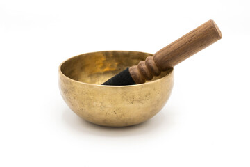Handmade Tibetan singing bowl with a stick, isolated on a White background