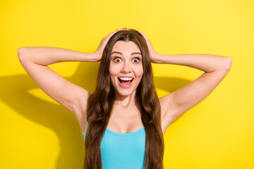 Photo portrait girl with long hair staring amazed with opened mouth isolated bright yellow color background