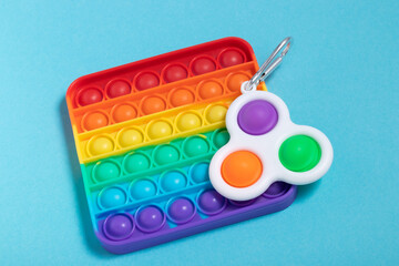 Rainbow antistress toys Pop It and Simple Dimple for the development of fine motor skills