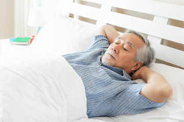 Senior man Suffering in bed cannot sleep from insomnia , Senior male , old man sleeping on bed in the morning - senior insomnia problem concept