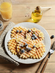blueberry waffles on a wooden background