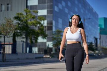 Fototapeta premium young woman exercising while listening to music with headphones