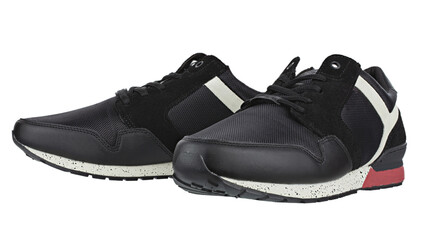 Stylish black sneaker made from a combination of faux leather and textile material and rubber sole isolated with white background. Casual shoes.