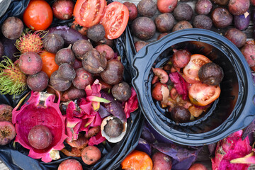 Rotten fruits and vegetables are sliced and piled together by homeowner to prepare for composting. Soft and selective focus on waste, concept for waste management at home.