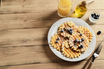 blueberry waffles on a wooden background