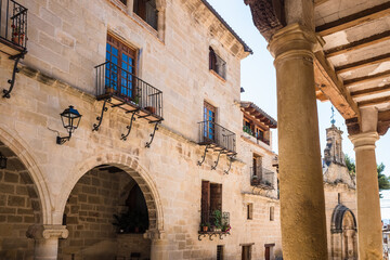 La Fresneda, Spain - July 11, 2021: Shaded atriums and patios between columns along the narrow streets of La Fresneda, Teruel.