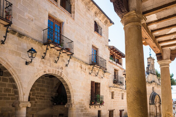 La Fresneda, Spain - July 11, 2021: Shaded atriums and patios between columns along the narrow...
