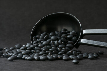 Black Lentils Spilled from a Teaspoon