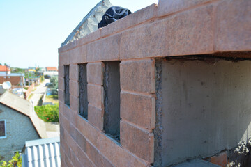 Masonry brick chimney construction. Building a brick chimney with multiple flues.