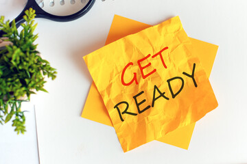 text get ready on crumpled yellow paper, concept