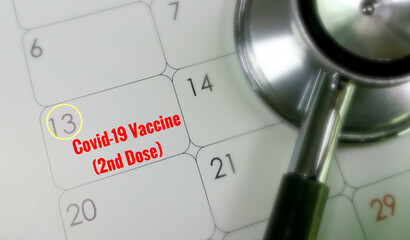 Covid-19 coronavirus vaccine (2nd dose) reminder on calendar with stethoscope. Concept of vaccination, herd immunity and pandemic healthcare