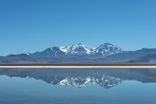 Snow Covered Nevado (volcano) Tres Cruces Reflecting In A High-altitude Lake Laguna Santa Rosa In Parque Nacional Nevado De Tres Cruces, Chile,  Atacama Desert