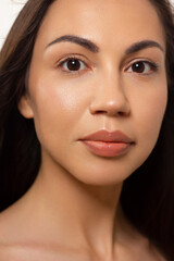Beauty closeup of women full red lips with shiny skin and long hair. Facial skin care in a spa salon or cosmetology and a fashionable natural lip gloss or lipstick. Smile and white teeth