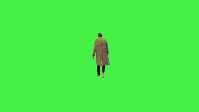Classic private detective undercover investigating suspicious spying on suspect walk sneaking on a Green Screen, Chroma Key.