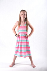 Beautiful school-age girl in the studio on a white background