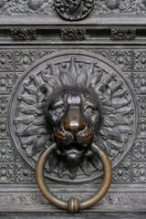 old metal door knocker doorbell lion. in lion shape