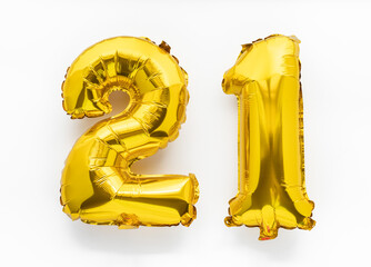 21 golden foil balloon numbers party decor on white background, birthday anniversary concept - 445626161