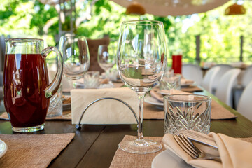 Empty wine glasses are on the table. A fragment of the serving.
