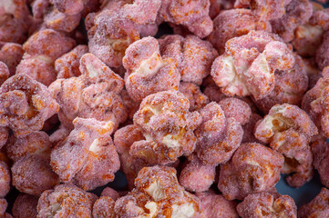 Gourmet sweet popcorn in close-up photo. Strawberry flavor. Top view