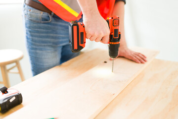 Close up of the male carpenter hands working with wood