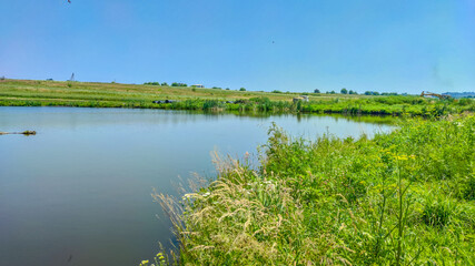 Landscape with a lake and clouds in the sky in the summer season
