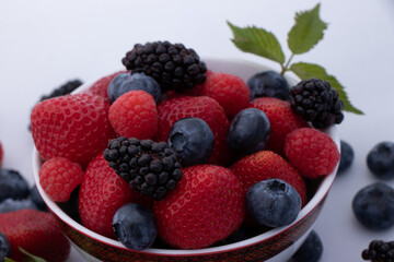 raspberries and blueberries in a bowl