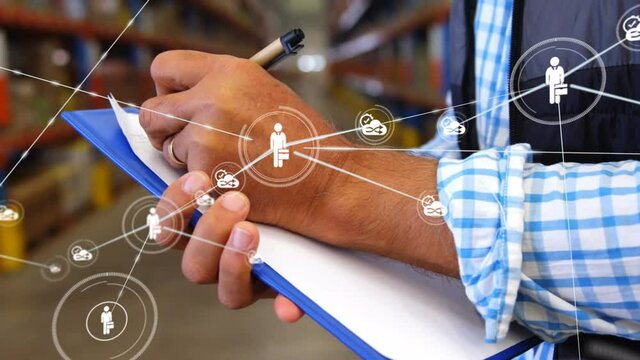 Animation of network of connections with icons over man making notes in warehouse