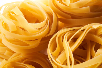 Italian egg pasta nest close-up. Fettuccine background
