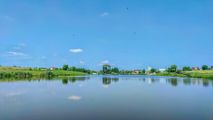 Landscape with a lake and clouds in the sky in the summer season