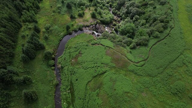 Aerial Footage Of The Loup Of Fintry Waterfall, Near The Village Of Fintry In Central Scotland. People Wild-water Swimming In The Pools At The Bottom Of The Cascade.