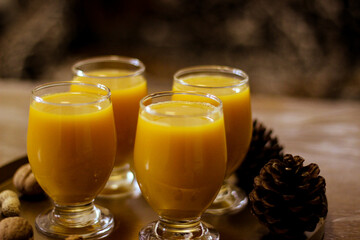 Four glasses of orange juice are on a tray