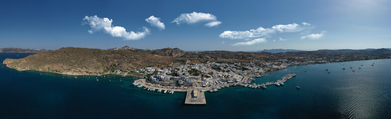 Aerial drone photo of picturesque village of Adamantas main port a natural calm sea bay and safe anchorage of yachts and sail boats in volcanic island of Milos, Cyclades, Greece